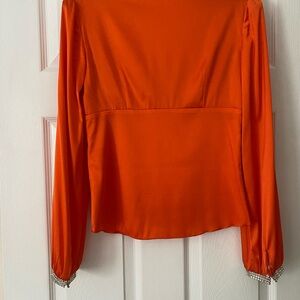 Trina Turk orange silk blouse with rhinestone cuffs.  Worn one time to a play